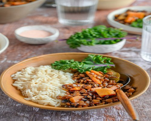 Homemade meal with lentils rice vegetables and yogurt
