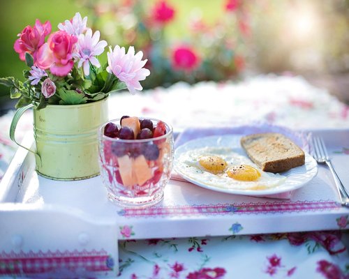 Balanced breakfast with eggs flatbread tea and fresh fruit